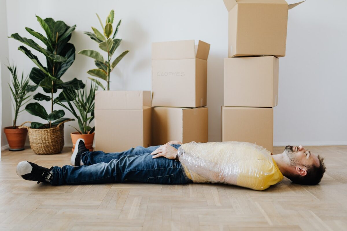 man lying on floor with relocation depression