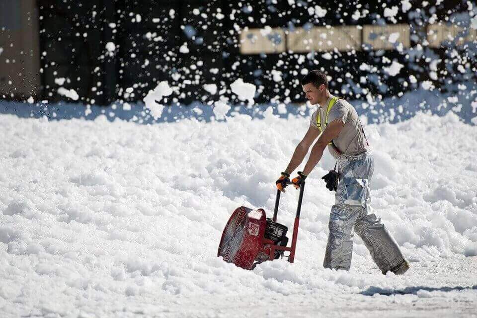 person cleaning snow after moving cross country