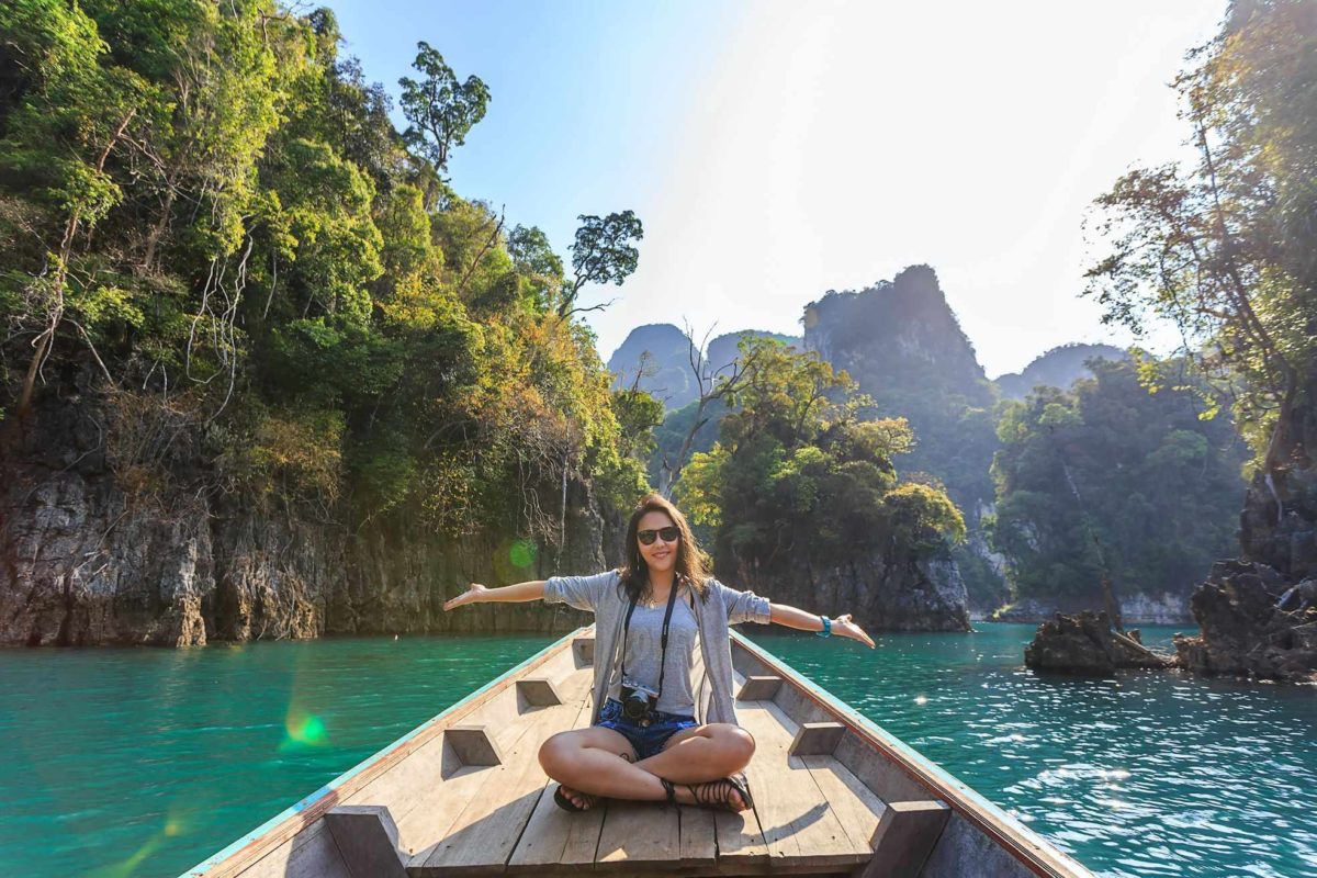 woman is travelling, sitting on a kayak