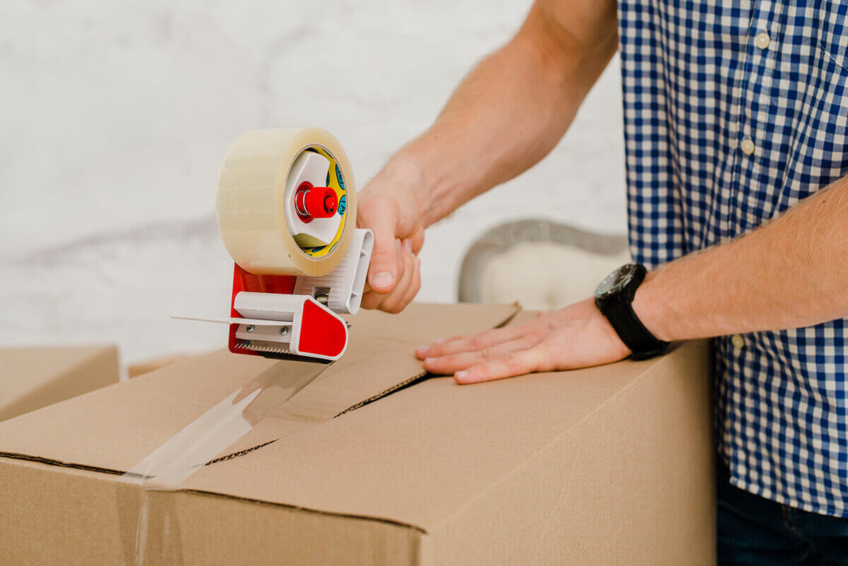 a man taping a box