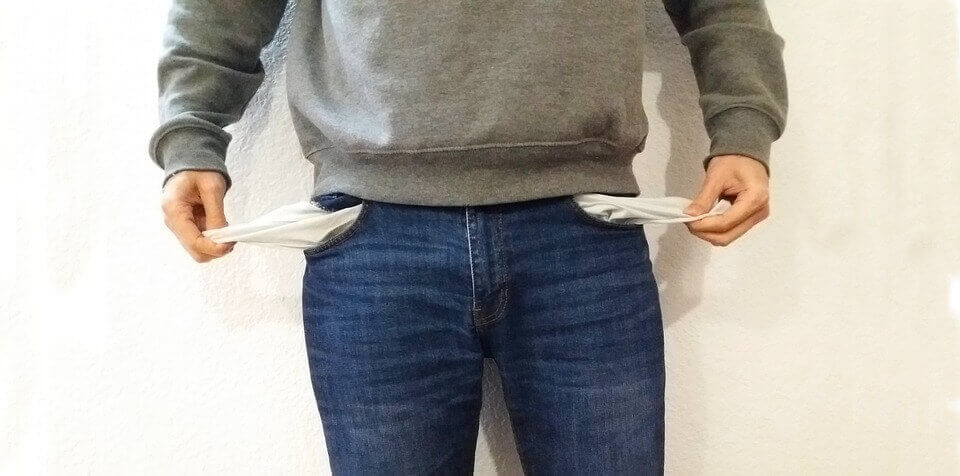 A man showing his empty pockets