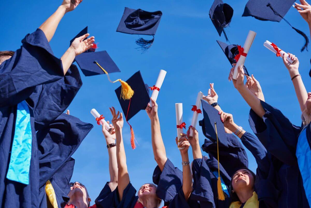 Students throwing their hats at a graduation