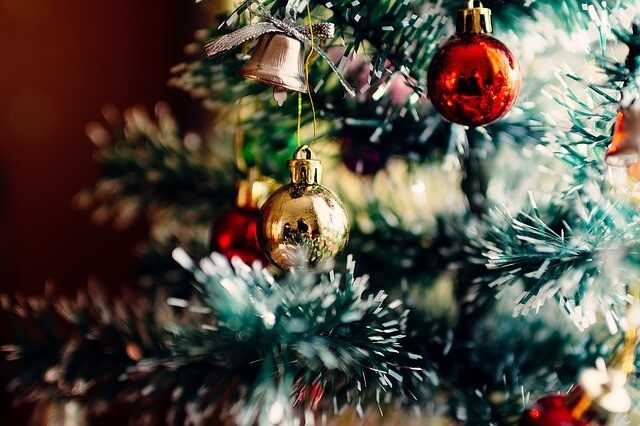 Christmas bulbs and a bell on a tree