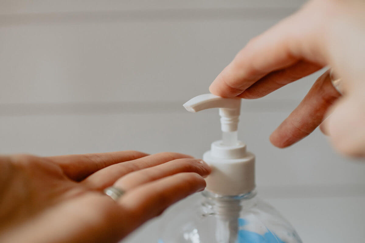 A person putting a hand sanitizer on their hands