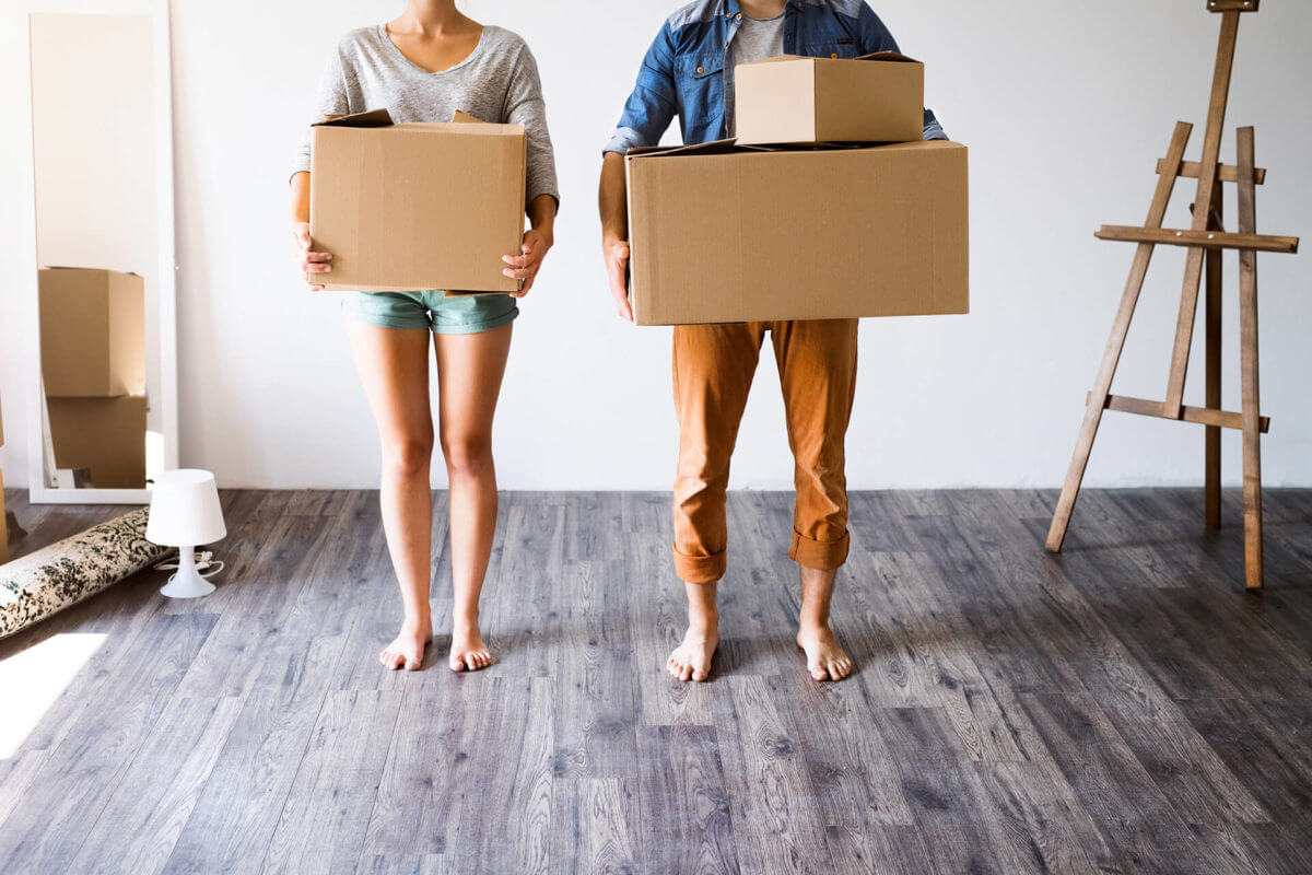 couple holding boxes and is ready for long distance moving