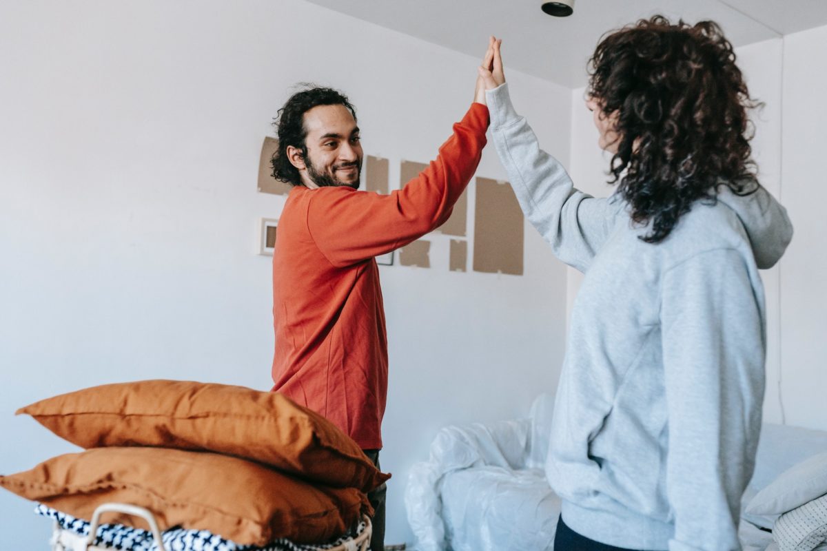 A couple doing high-five during cross-country moving process