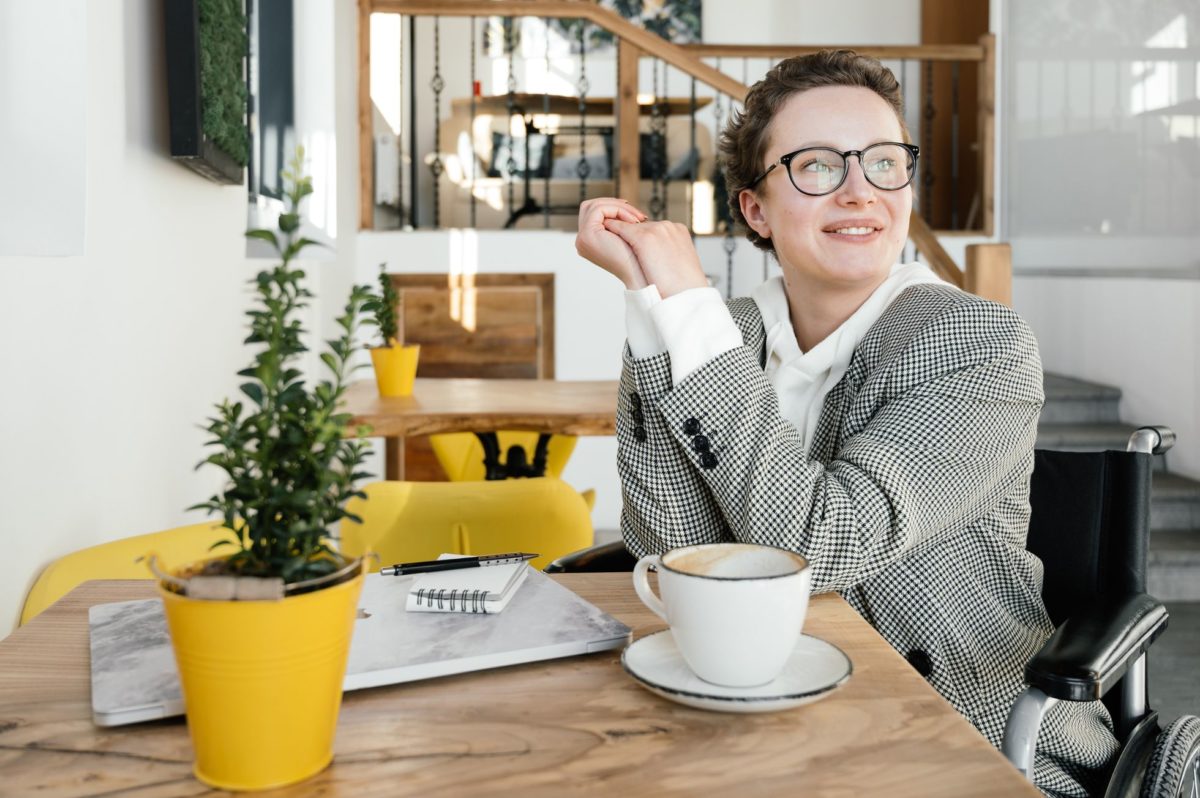 woman is sitting and drinking coffee