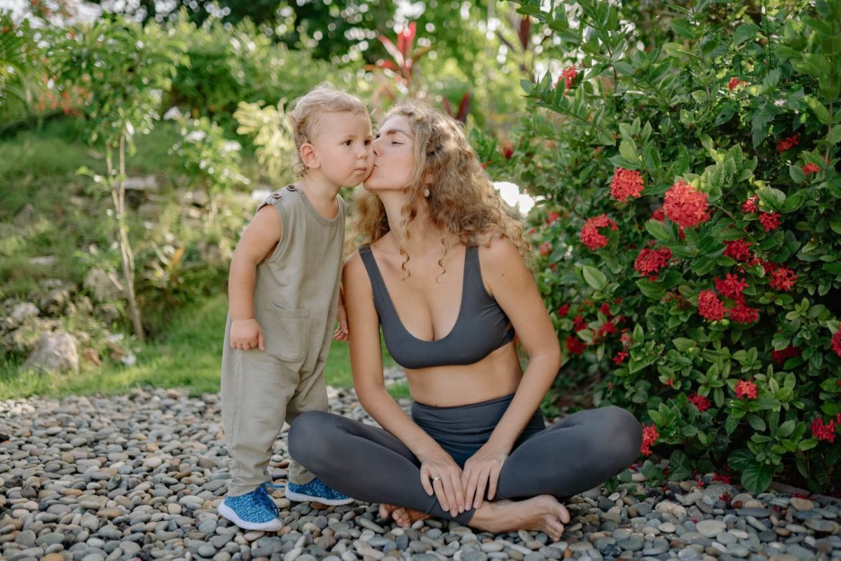 A mother kissing her child on the cheek