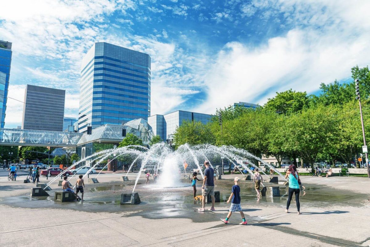 an image of people playing in a street fountain in Portland, OR