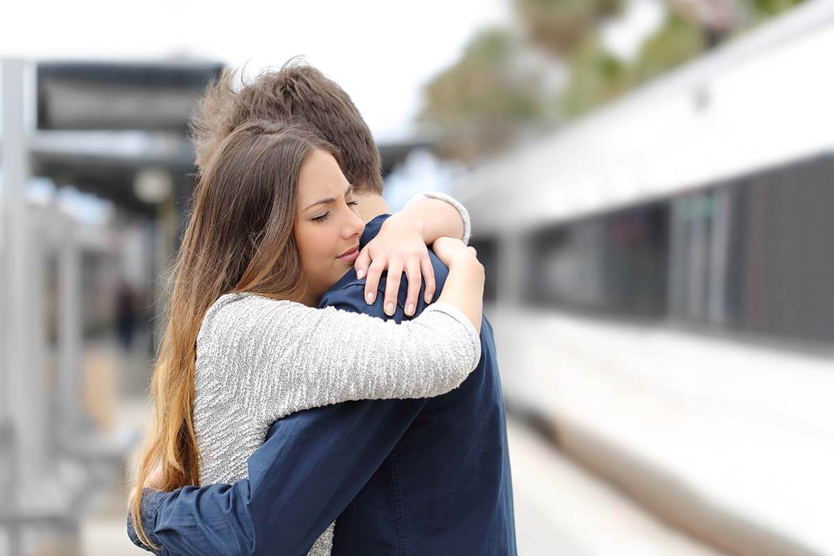 Two people hugging after agreeing upon which cross country movers to hire