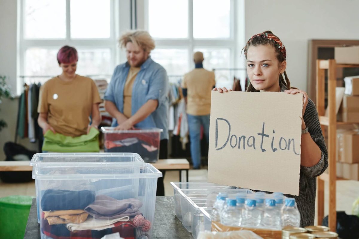 Girl donating her clothing before long-distance moving