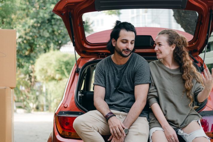 couple is packing car to move