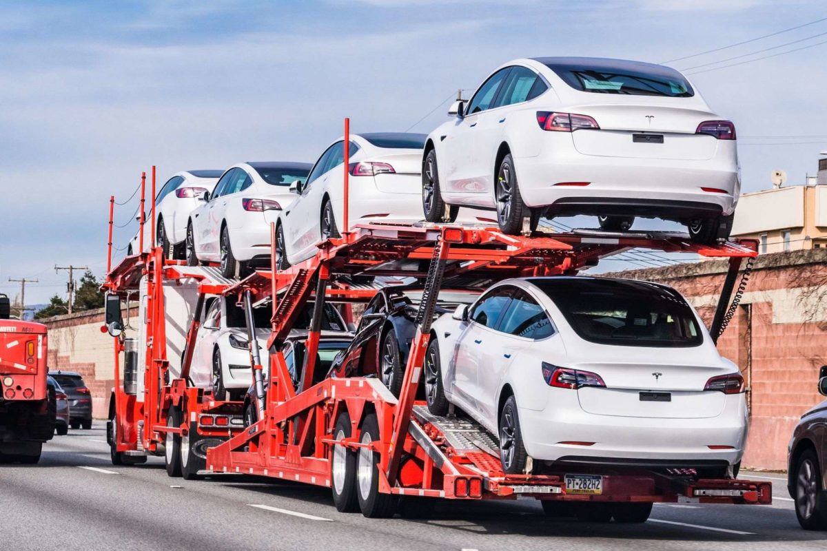 Cars on an open trailer ready for long-distance moving