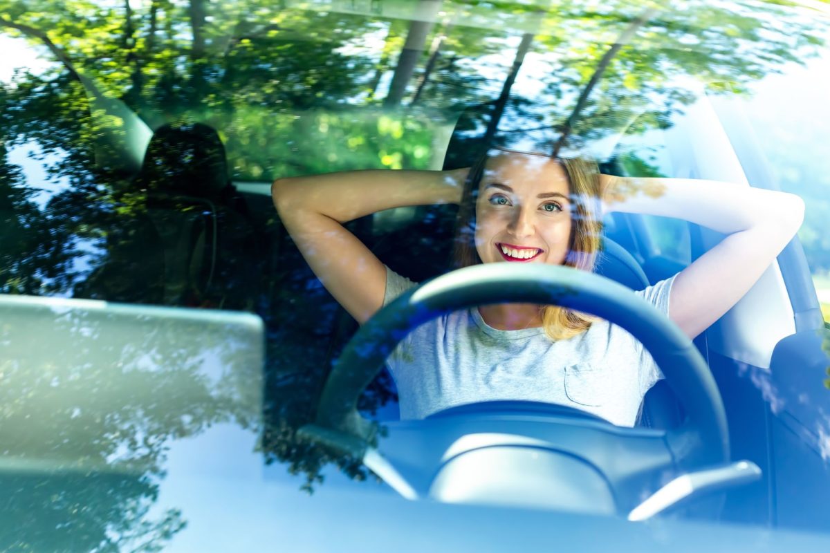 woman in car getting ready for long distance moving