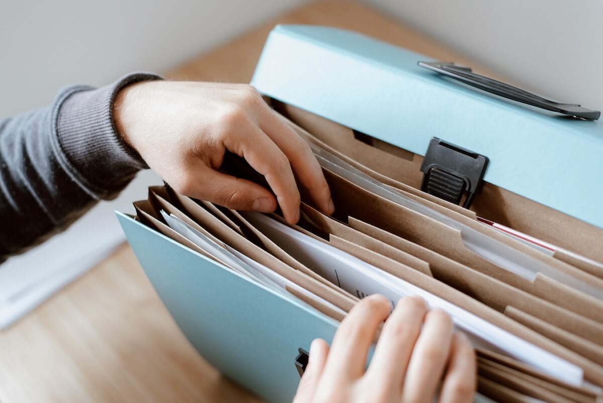Person choosing a document in a folder