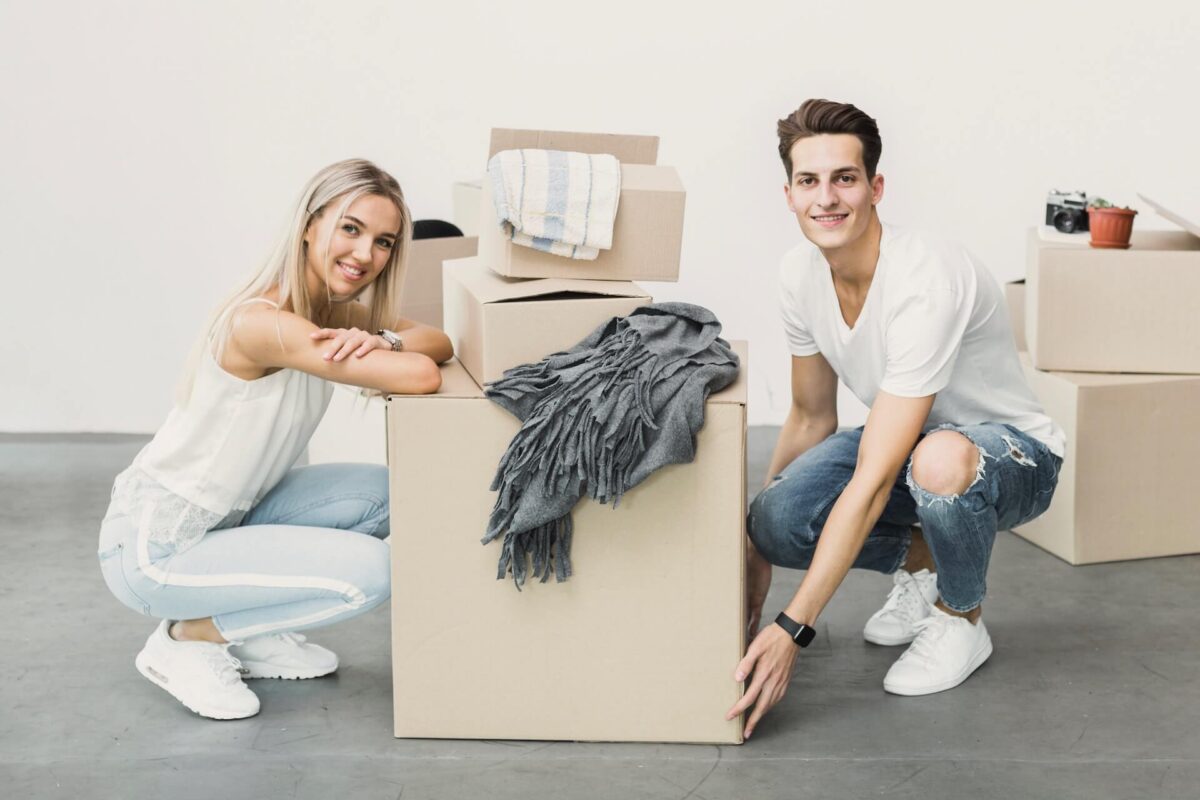 A man and a woman packing boxes for long-distance moving