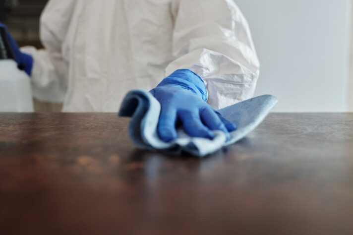 Close up photo of a person cleaning a table
