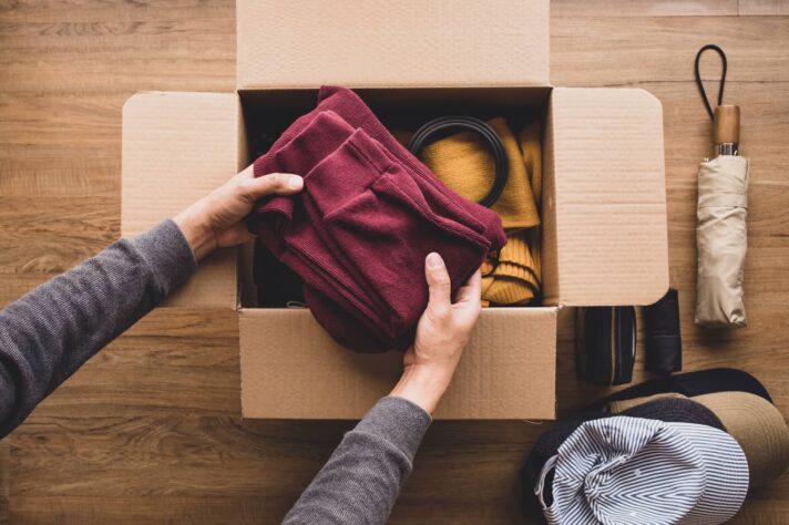 Person packing clothes before moving cross country
