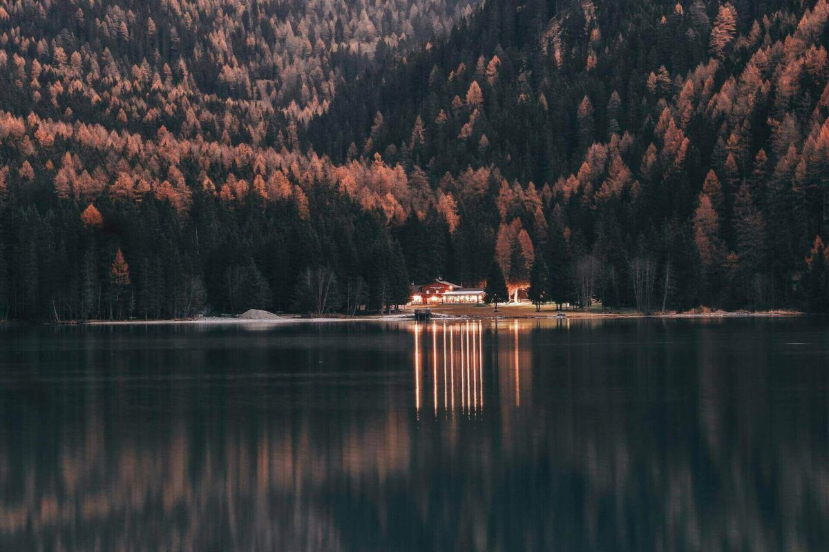 A landscape of a house on a lake