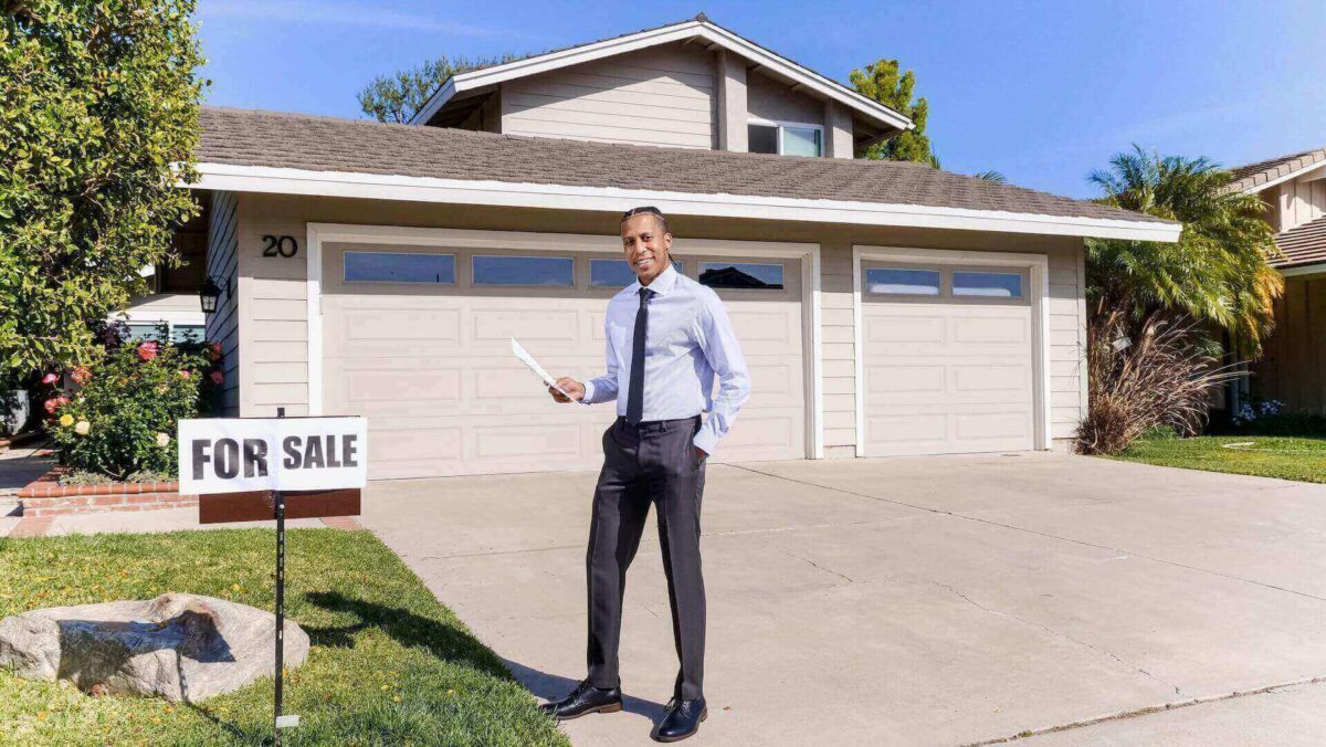 A real estate agent in front of a house