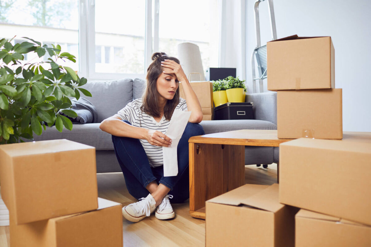 Panicked woman surrounded by boxes and getting ready for moving cross country