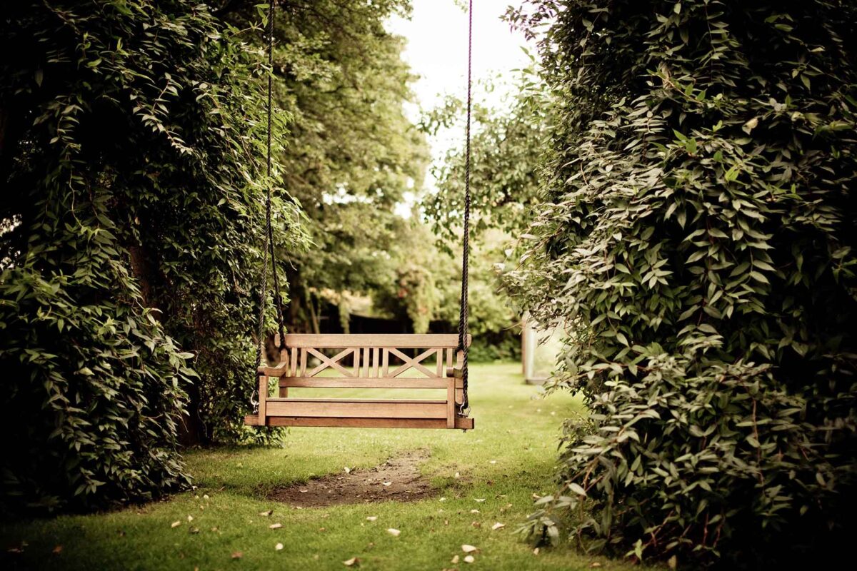 Garden swing hanging from ropes