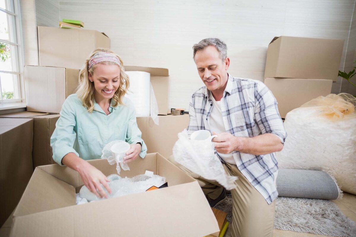 Couple packing their fragile items for long-distance moving