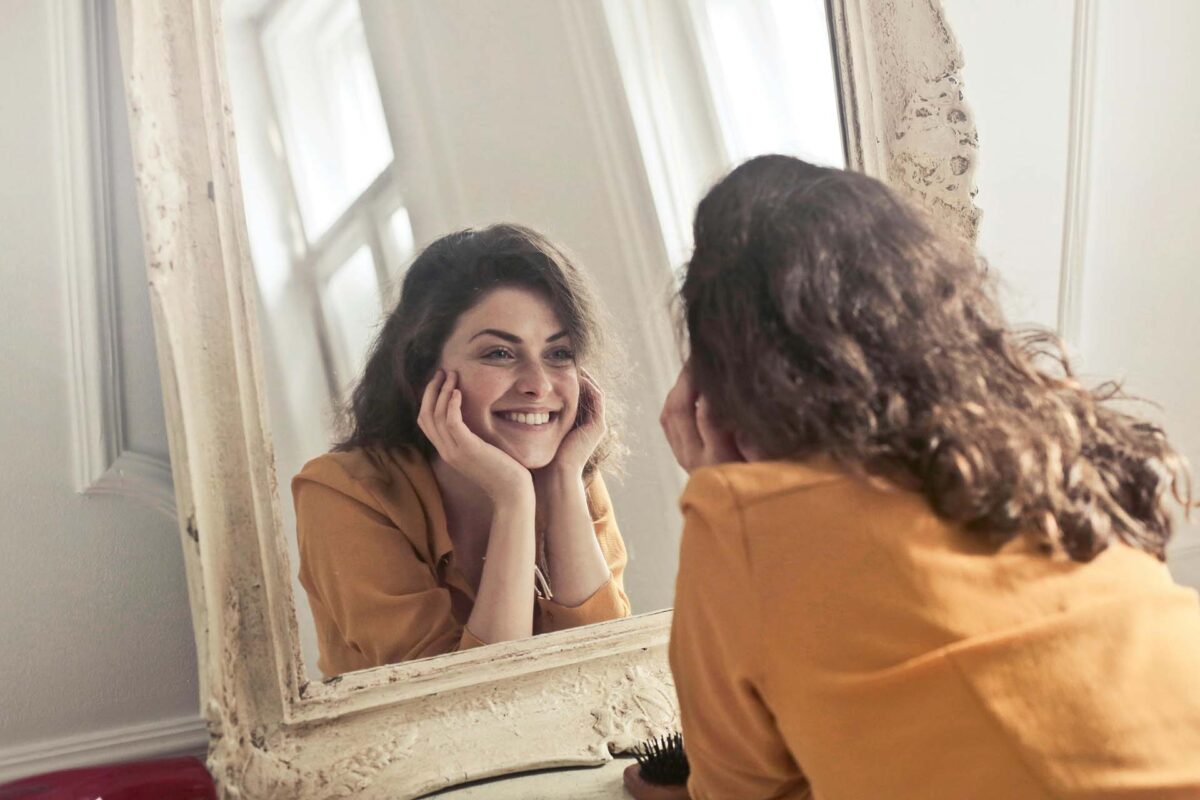 A woman looking at herself in a mirror
