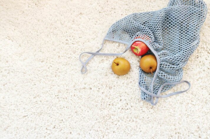A pile of apples on a carpet