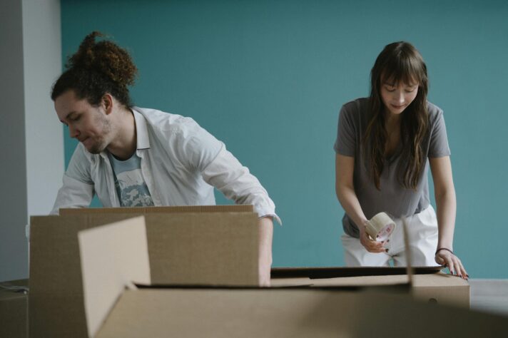 Couple prepares boxes for relocation