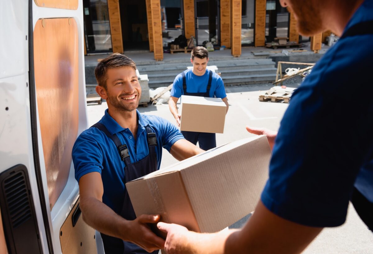 Movers loading a long-distance moving truck on a city street